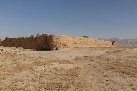 Ancient mud brick fortress ruins in Balkh Province, Afghanistan with a distant mountain range