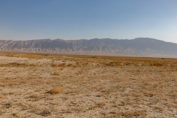Arid desert landscape of Balkh Province in Afghanistan with a vast mountain range behind