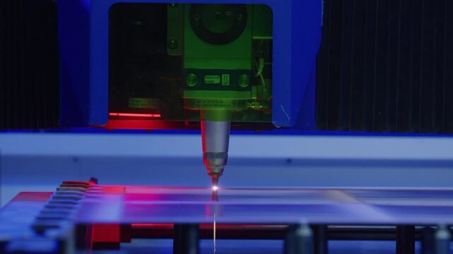 Precision industrial laser cutting plexiglass sheet with advanced automation, demonstrating high tech manufacturing capabilities in modern factory environment