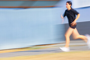  teenager girl running Sity street. Blur.