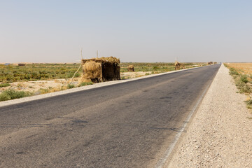 Rural roadside stalls made of straw on a highway in the desert landscape of Jowzjan Afghanistan