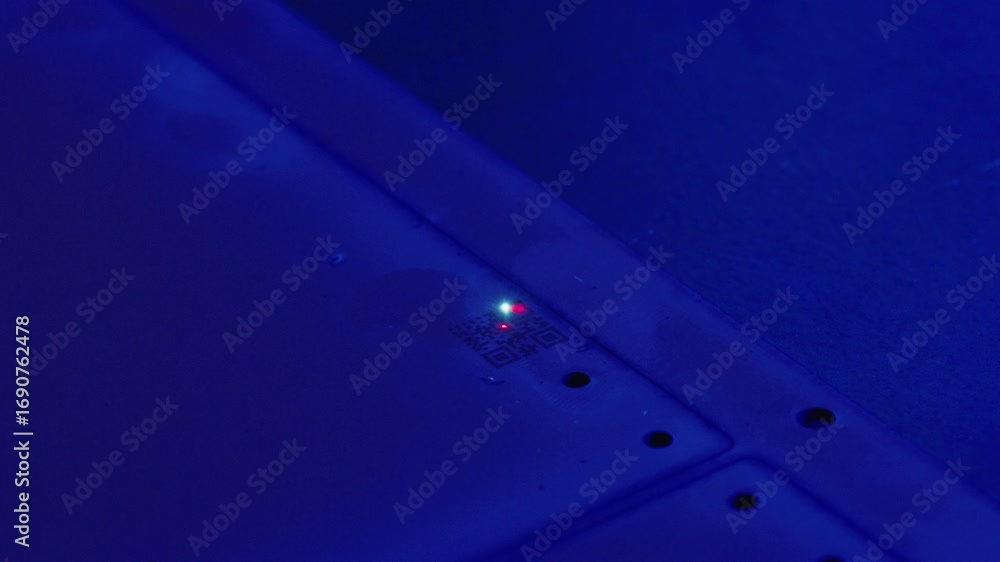 Poster printed circuit board illuminated under blue light, displaying blinking red and green lights highlig