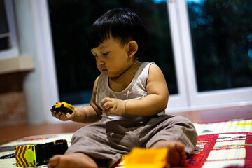 Toddler Playing with Toy Car in the Living Room