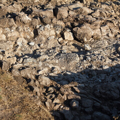 Archaeological work excavation site with exposed detailed soil layers and chalky terrain