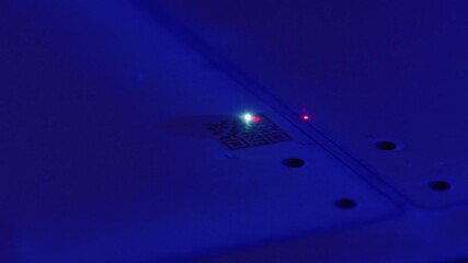 Green led blinking next to quick response code, illuminating white surface with soft blue light, representing digital communication technology and electronic innovation