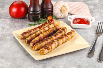 Grilled meat sausages wrapped bacon