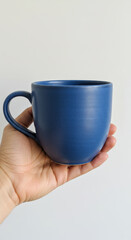 Hand Holding a Cobalt Blue Ceramic Mug