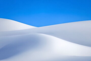 Captivating snowy landscape under clear blue sky; serene winter scene for nature enthusiasts seeking breathtaking, peaceful wilderness experiences.