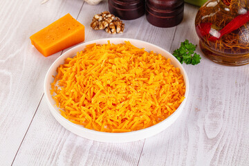 Yellow shredded cheddar cheese in the bowl