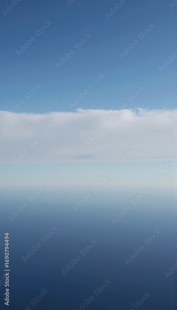 Poster expansive view of a serene ocean blending into a clear blue sky marked by a distant horizon and soft