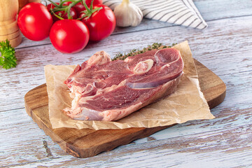 Raw lamb steak with bone
