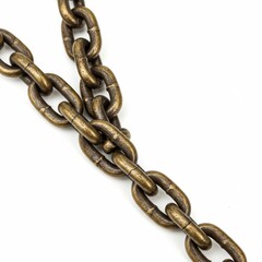 Obraz premium Antique brass chain lies diagonally on a white surface.