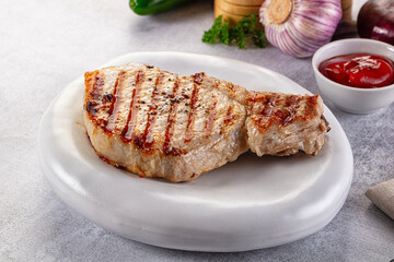 Tasty hot grilled bone steak served sauce