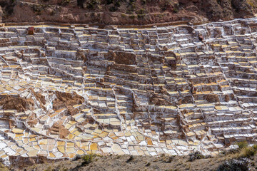 Salineras de Maras in Peru natural salt pools on the mountain terraces tourist attraction and famous sight of Sacred valley of Incas near Cusco. Salt bassins on the mountain slopes in Peru