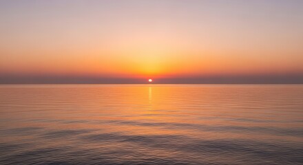 Naklejka premium Beautiful orange sunset sky over a calm sea horizon with sun setting. Golden hour and seascape concept.
