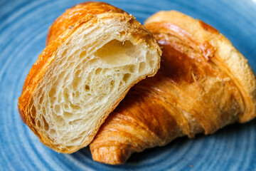 Single Butter Croissant Cut In Half On A Plate