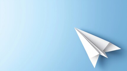 Fototapeta premium A white paper airplane against a light blue background.