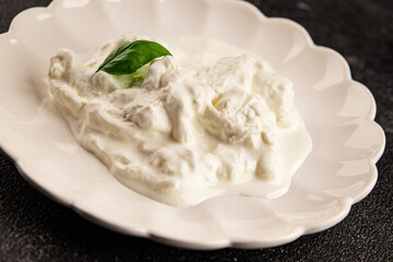Stracciatella cheese soft young portion size Italian food natural product tasty snack fresh delicious gourmet food background on the table rustic top view copy space