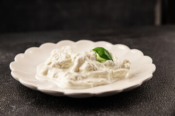 Stracciatella cheese soft young portion size Italian food natural product tasty snack fresh delicious gourmet food background on the table rustic top view copy space