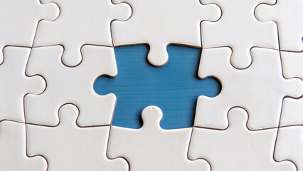 Puzzle pieces fitting together, creating sense of completion and unity, with one piece missing, symbolizing need for connection and resolution