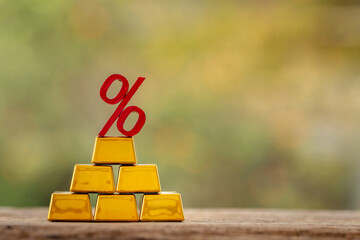 Stack gold bar with high as financial value for invest put on the old wood on the morning sunlight...