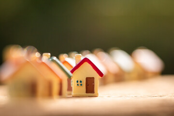 Home model for select put on the old wood on sunlight, in the public park, Loan for real estate or...