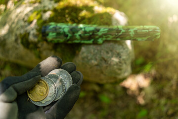 Coins found by a treasure hunter using a pinpoint. A hobby of finding coins in the ground.