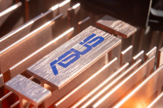 The Asus company logo on the cooling element of the computer.The asus brand name is blue.