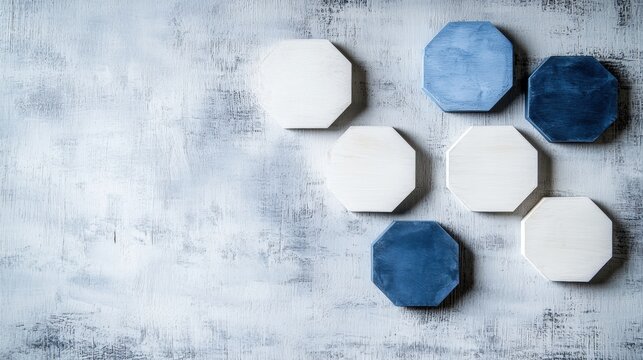 A collection of octagonal objects in various shades of blue and white, arranged on a textured gray background.