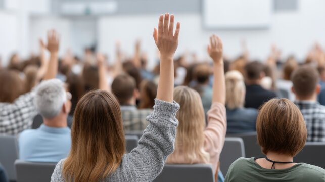 Engaged Audience Raising Hands for Participation in a Seminar or Workshop in a Large Conference Room Setting