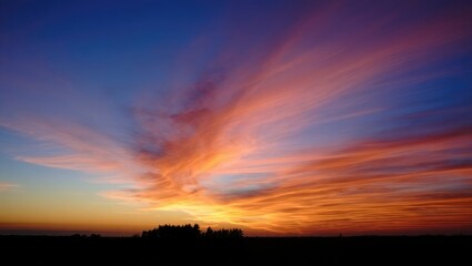 Obraz premium Dramatic Sunset Sky with Fiery Orange and Blue Clouds