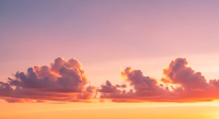 Obraz premium Warm sunset sky with soft fluffy clouds creating a beautiful and tranquil atmosphere