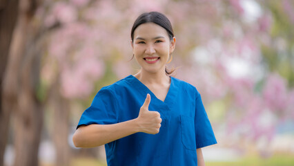 Nurse caregiver with elderly woman enjoying beneath blooming trees. suggesting in healthcare...