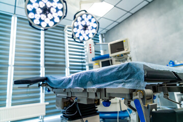 Surgical room equipped for operations. Bright surgical room with procedure table and advanced...