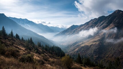 Obraz premium Breathtaking mountain valley landscape under a cloudy sky
