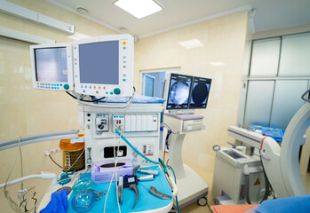 High-tech surgery tools. High-tech surgical instruments and monitors are set up in a modern...