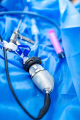 Surgical tools on blue surgical drape. Detailed view of surgical instruments placed on a blue drape...