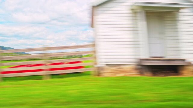 Blue Grass village in Highland county, Virginia countryside, car driving point of side view by farm shed barns houses at Appalachian mountains