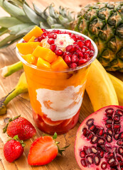 Layered Tropical Fruit Smoothie with Vanilla Ice Cream, Pomegranate, Mango, Strawberry, Pineapple,...