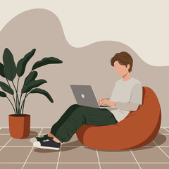 Young person working comfortably on a laptop from a bean bag chair at home. Represents remote work, online learning, or modern casual lifestyle.