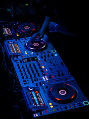 Czech Republic - Prague - 24.8.2025 DJ setup with glowing turntables in blue light, creating an...