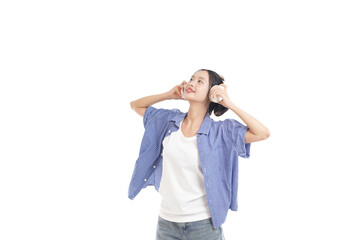 Serene Listening: A woman with her eyes closed, listening to music through headphones, captures a...