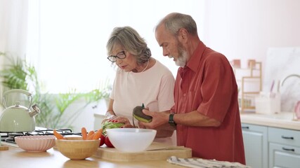 Senior couple preparing food in modern kitchen - Powered by Adobe