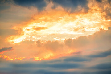 Dramatic sunset clouds creating a vivid canvas of vibrant colors in the evening sky over a tranquil...