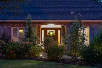 Entrance of luxury house with nice green Summer landscape at night in Vancouver, Canada, North America. August 2025.