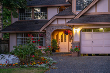 Entrance of luxury house with nice green Summer landscape at night in Vancouver, Canada, North America. August 2025.
