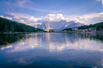 Famous Lago di Misurina alpine lake in South Tyrol Italy with mountain backdrop, forest and village...