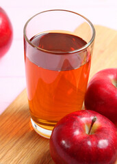 apple juice from red apples on the table.. Vertical photo format