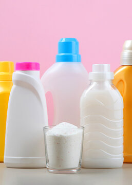 Laundry detergent bottles and clothes on the table. Household chemicals. Vertical photo format 