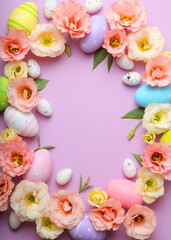 Flowers and Easter eggs on a colored background close-up. Easter background. Vertical photo format 